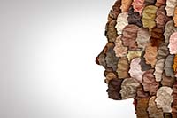 Abstract illustration of a human face constructed of dozens of smaller faces rendered as multicolored paper